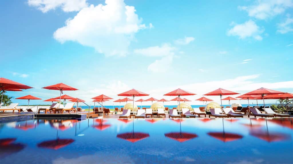 Sundrella Umbrellas with a skyline and reflecting in the pool.